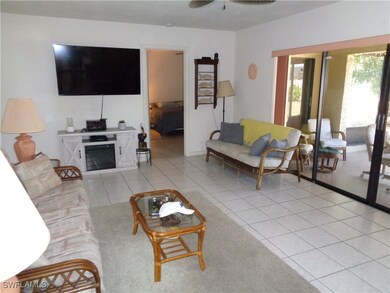 Living area with a fireplace, light tile patterned