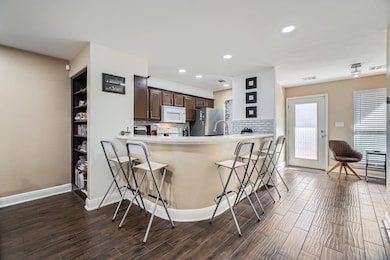 Kitchen with white microwave, freestanding refrig