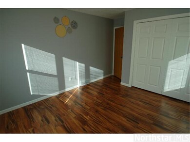 Bedroom 1 with wood floor and lots of natural ligh