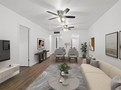 Living room with wood finished floors and a ceiling fan