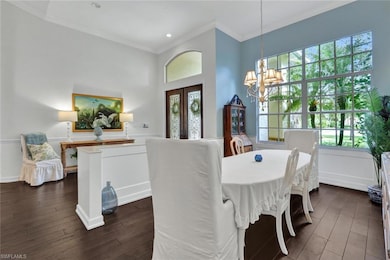 Dining room with a chandelier, french doors, dark 