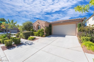 Mediterranean / spanish-style house with a tile roof, stucco siding, concrete driveway, and an attached garage