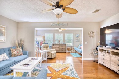 Living room featuring a textured ceiling, light wo