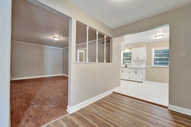 Hall with light hardwood / wood-style floors, crow