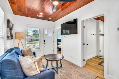 The space flows into a clean, contemporary bathroo