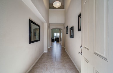 Welcoming entryway with tiled flooring, high ceili