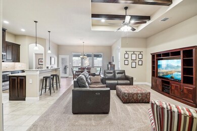 Tiled living room featuring beam ceiling and ceili