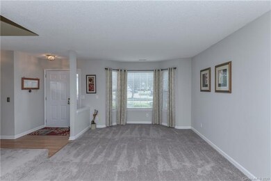 Formal living room off the foyer connects to dinin
