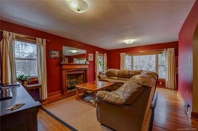 Living room with hardwood floors and woodburning f