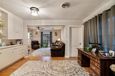 Living room featuring ceiling fan, a textured ceil