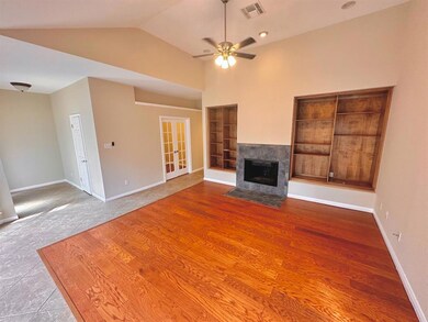 Unfurnished living room featuring a ceiling fan, 