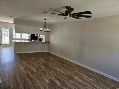 Unfurnished living room with ceiling fan with nota