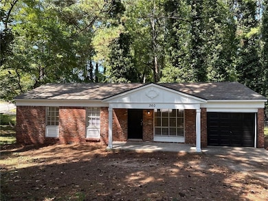 Ranch-style house featuring covered porch, brick siding, a garage, a shingled roof, and driveway