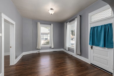 Family/ Front Room featuring dark wood finished floors and baseboards