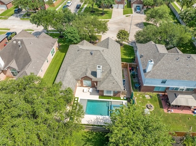 This aerial view showcases a suburban home with a