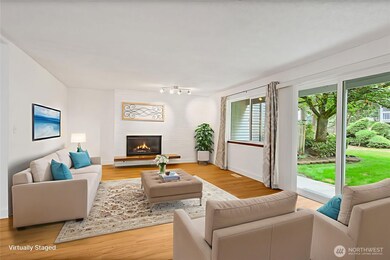 Living room with fireplace and views of gardens