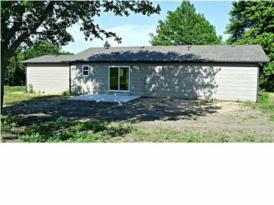 Back of home with patio