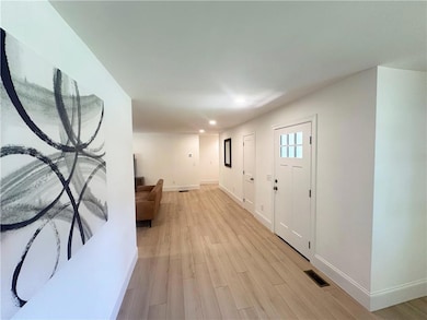 Foyer entrance featuring recessed lighting and light wood-style floors