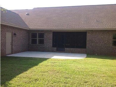 Patio off of screened porch and door to garage