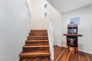 Staircase with baseboards and wood finished floors