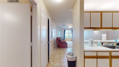 Kitchen featuring white cabinets, sink, ceiling fa