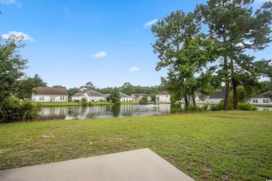 View of grassy yard featuring a residential view and a water view
