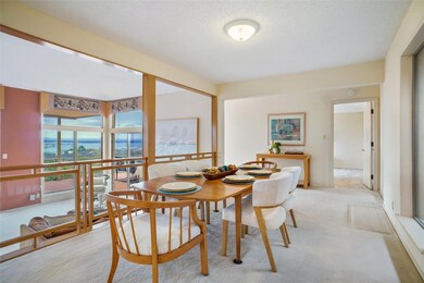 Dining room featuring light carpet and a textured
