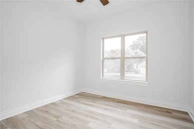 Spare room featuring ceiling fan and light hardwoo
