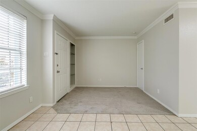 Unfurnished bedroom with crown molding and light t