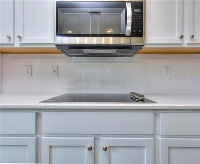 Kitchen view of stainless steel microwave, black e