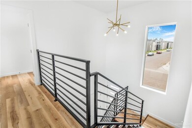 Stairway featuring wood finished floors and a chandelier