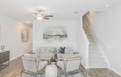 Dining room with a ceiling fan, stairs, baseboards