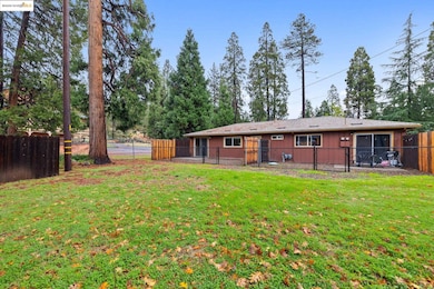 Back of house with a fenced backyard