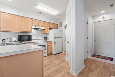 Kitchen featuring light countertops, light brown c