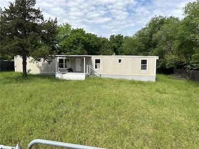 Rear view of house with a lawn and fence
