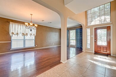 Open formal living and formal dining with wood floors