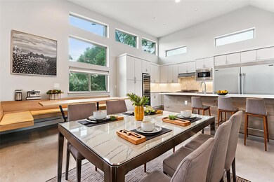 Dining room featuring a towering ceiling, wine co