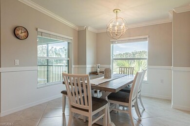 Dining space featuring a chandelier, plenty of natural light, crown molding, and light tile patterned floors