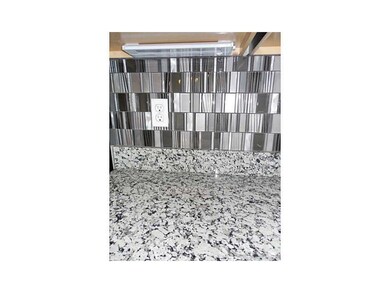 . Kitchen granite and back splash with under cabin