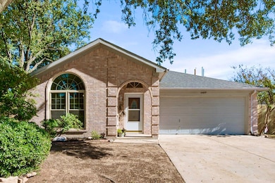 View of front of property with brick siding, concrete driveway, an attached garage, and roof with shingles