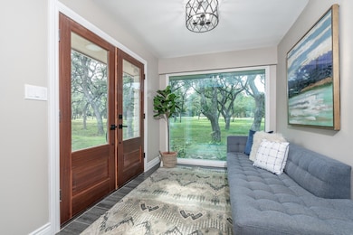 Foyer featuring french doors, wood finished floor