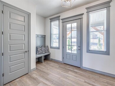 Doorway to outside with light hardwood / wood-styl