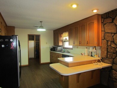 A kitchen and bar area join the den
