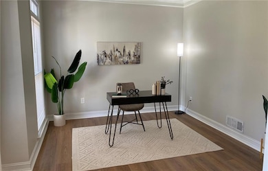 Office featuring dark wood-style floors and basebo