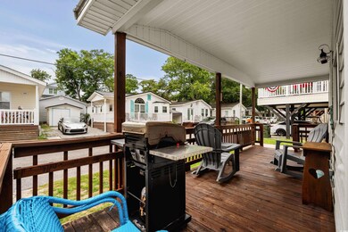 Wooden terrace with an outdoor structure and a residential view