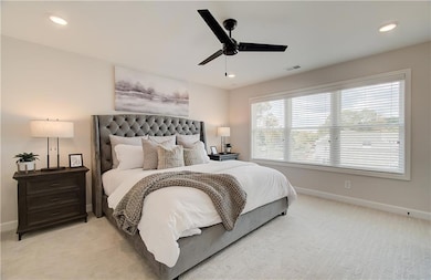 Primary bedroom is light and bright and features a king bed.