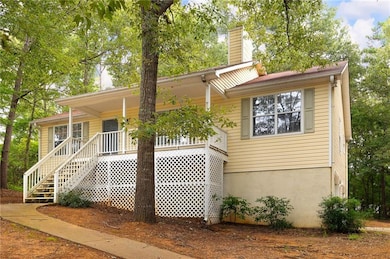View of front of house featuring a chimney, a porch, and stairway