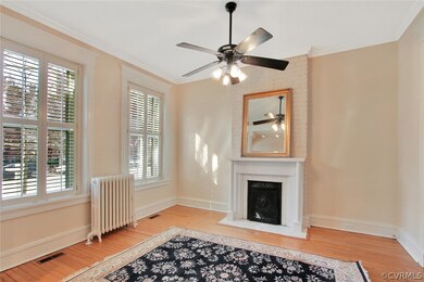 Front parlor. Fireplace, columned entrance, 10 foot ceilings.