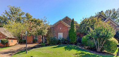 View of front of home with a front lawn and brick siding