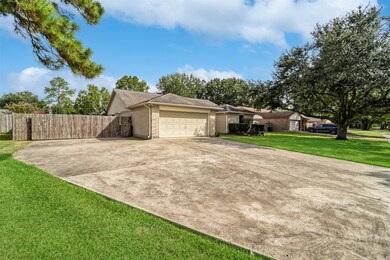 Along the left side of the home, an extra wide driveway leads to the 2-car attached garage, along with a rolling side gate that allows access to the paved backyard parking pad that is suitable for an RV, trailer, boat, or sports court.